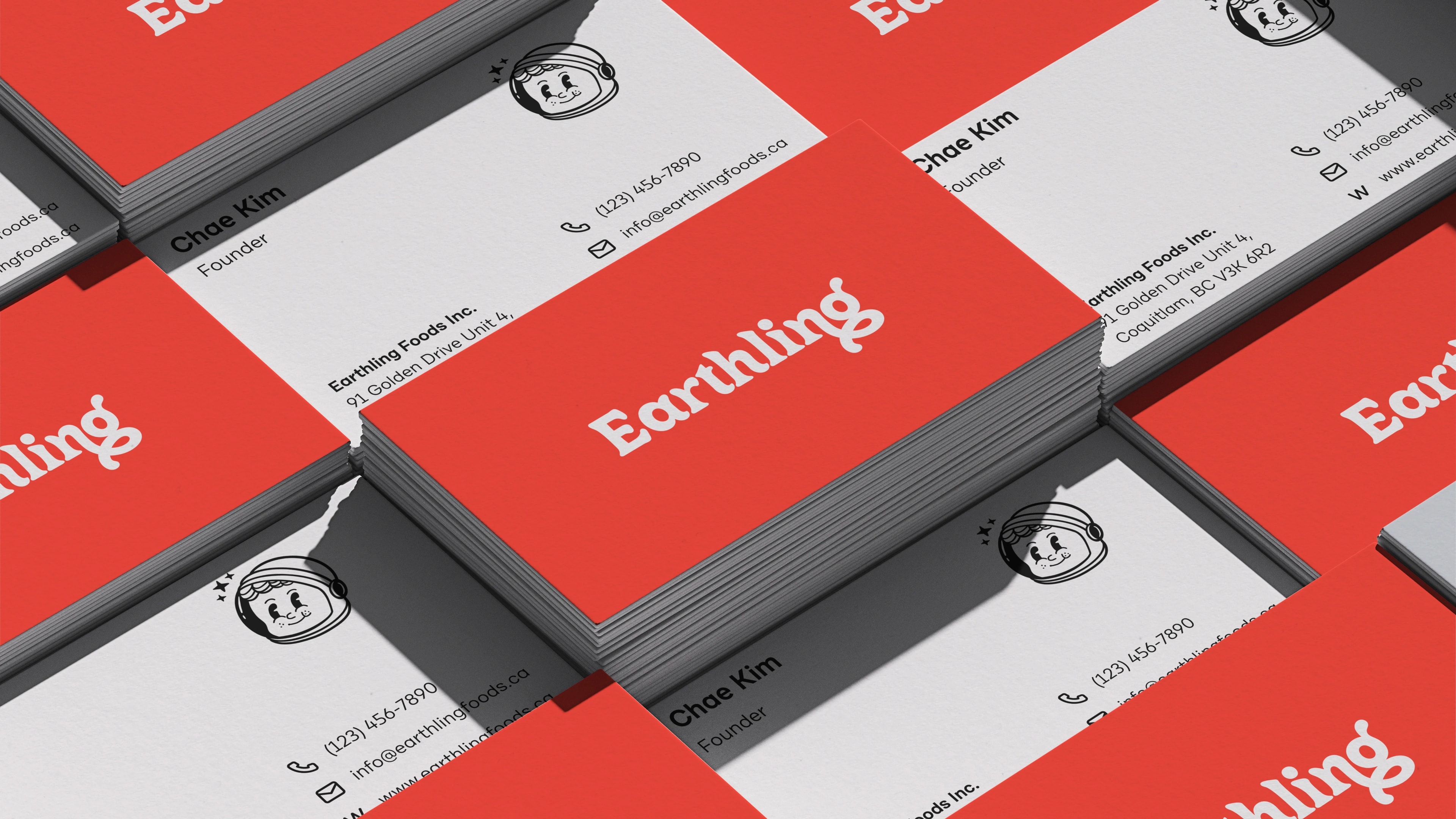 Earthling business cards, the wordmark on the red reverse and the astronaut mark on the front